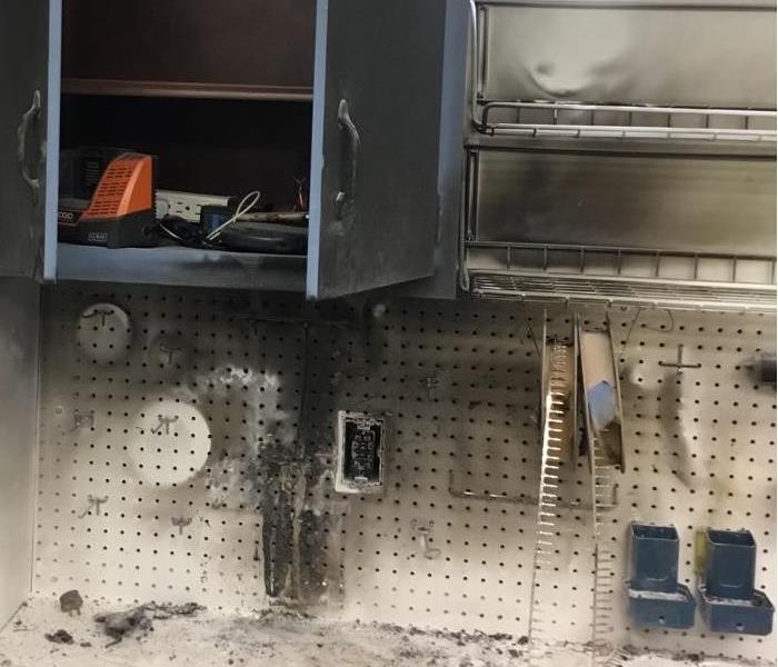 Fire damage to wall and cabinet